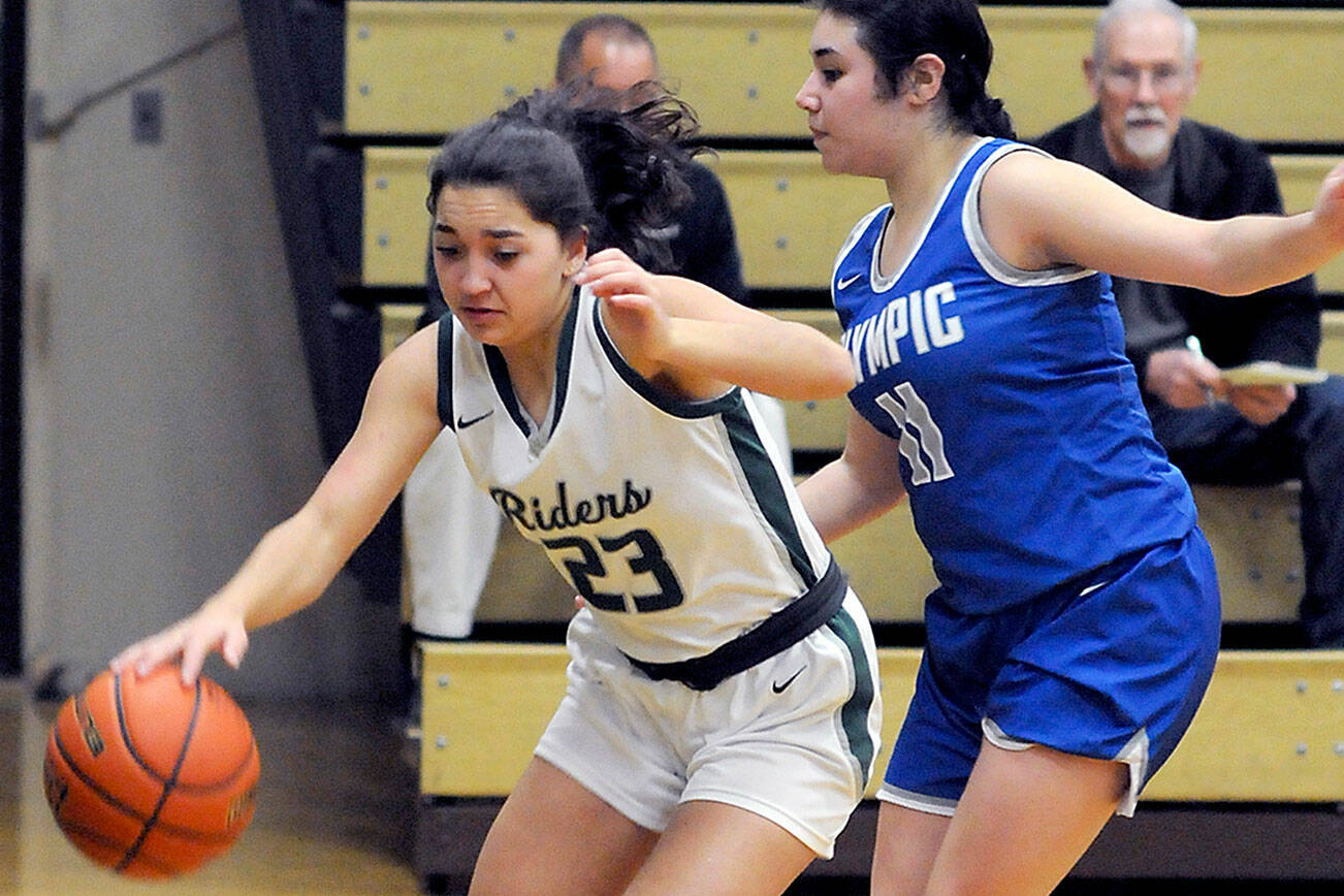 KEITH THORPE/PENINSULA DAILY NEWS
Piper Williams of Port Angeles dribbles in on the baseline as Olympic's Angelina Godinez-Gonzalez guards the approach on Thursday night at Port Angeles High School.