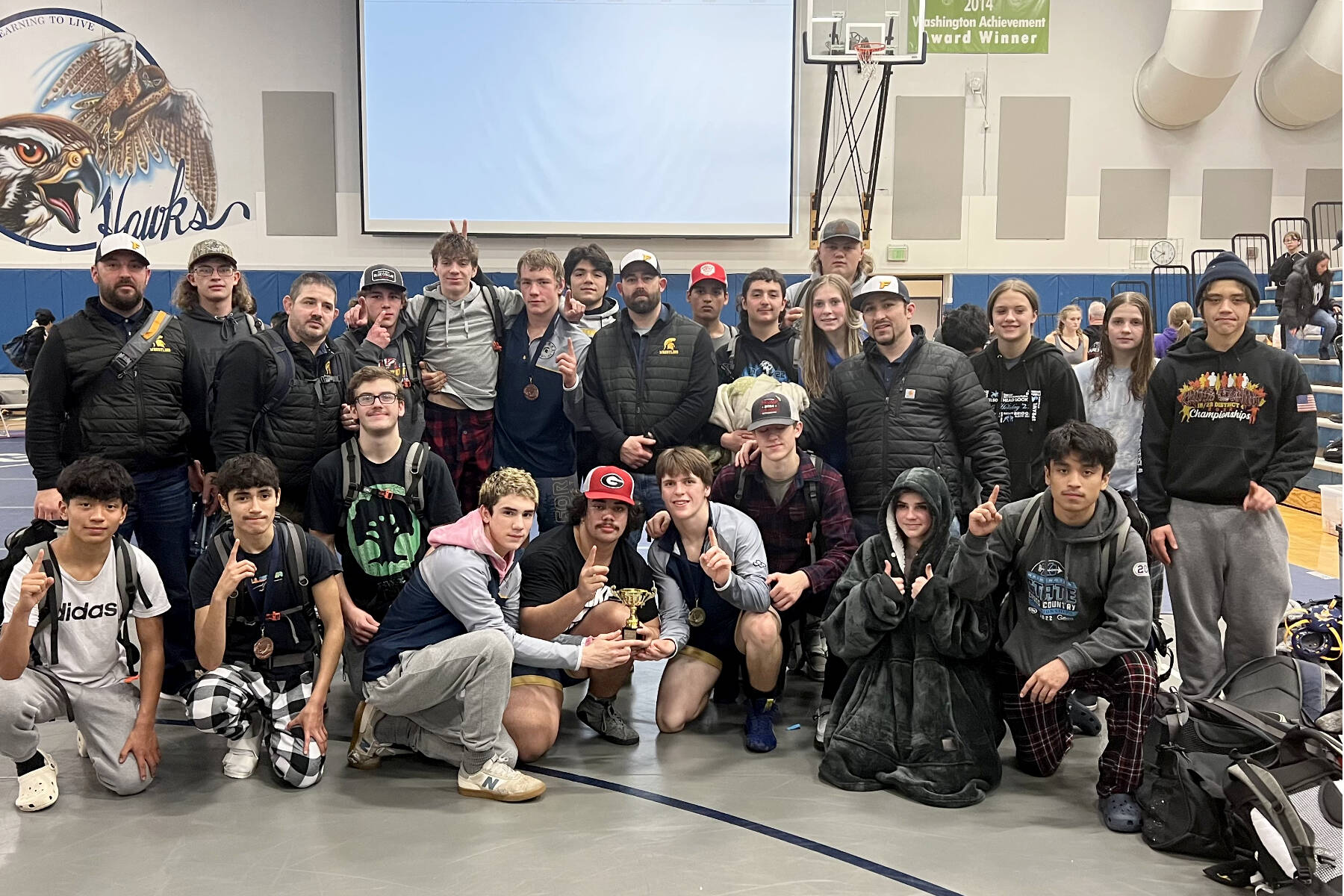 Courtesy of Forks wrestling
The Forks wrestling team celebrates the boys' seventh tournament victory this season at the River Ridge Rumble in Lacey this weekend. The Spartans beat out mostly 3A and 4A schools to win this tournament.