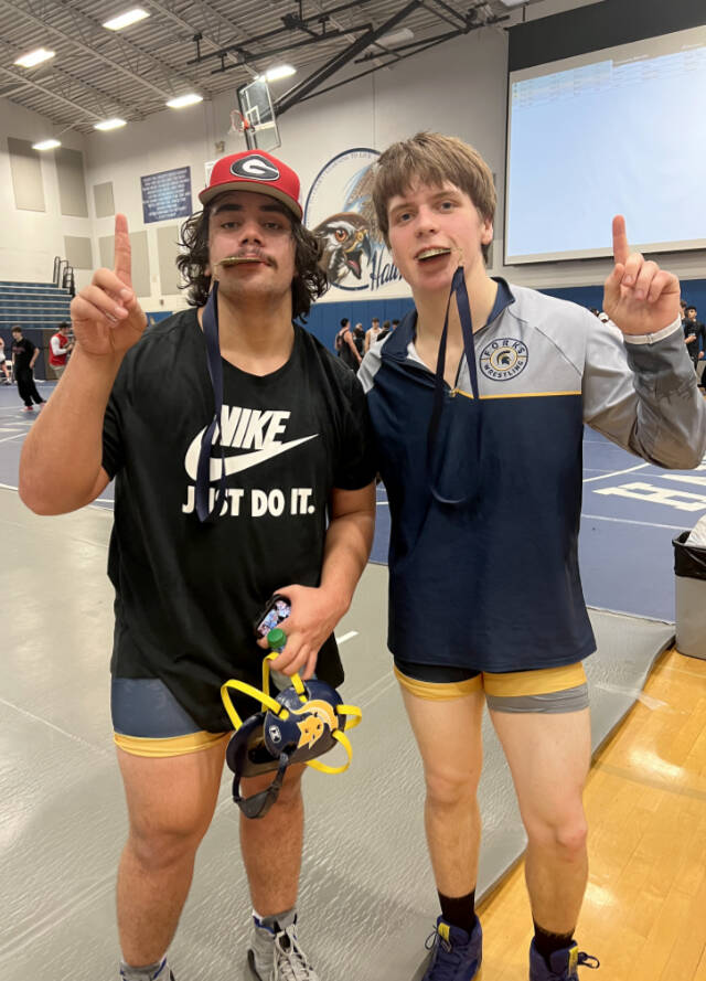 Forks’ Sloan Tumaua, left and Kaleb Blanton celebrate their first-place finishes at the River Ridge Rumble in Lacey this weekend. Tumaua won at 220 pounds and Blanton at 152 pounds. (Courtesy of Forks Wrestling)