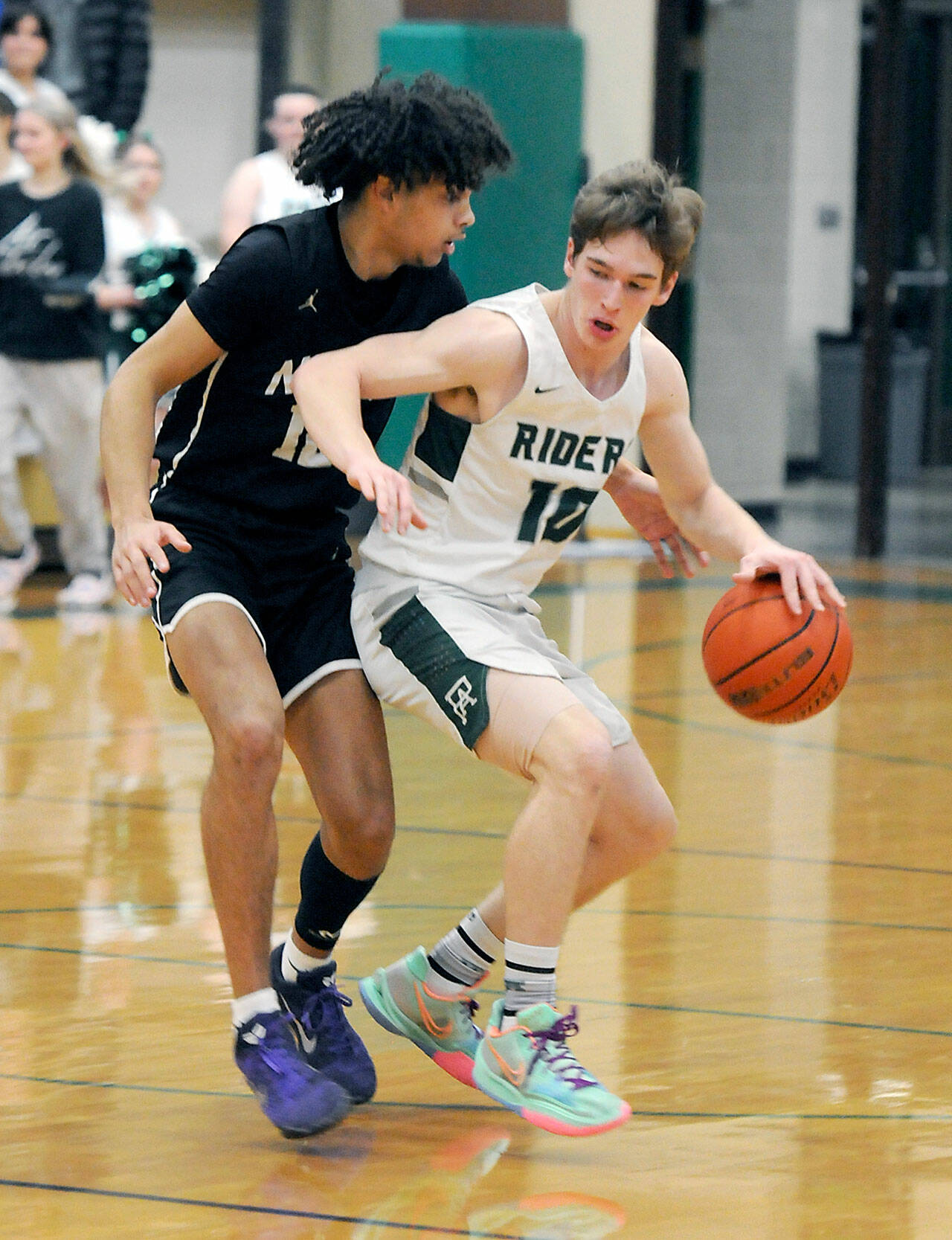 KEITH THORPE/PENINSULA DAILY NEWS Port Angeles’ Josiah Long, right, pushes off the defense of North Kitsap’s Harry Davies during Thursday’s game at Port Angeles High School.