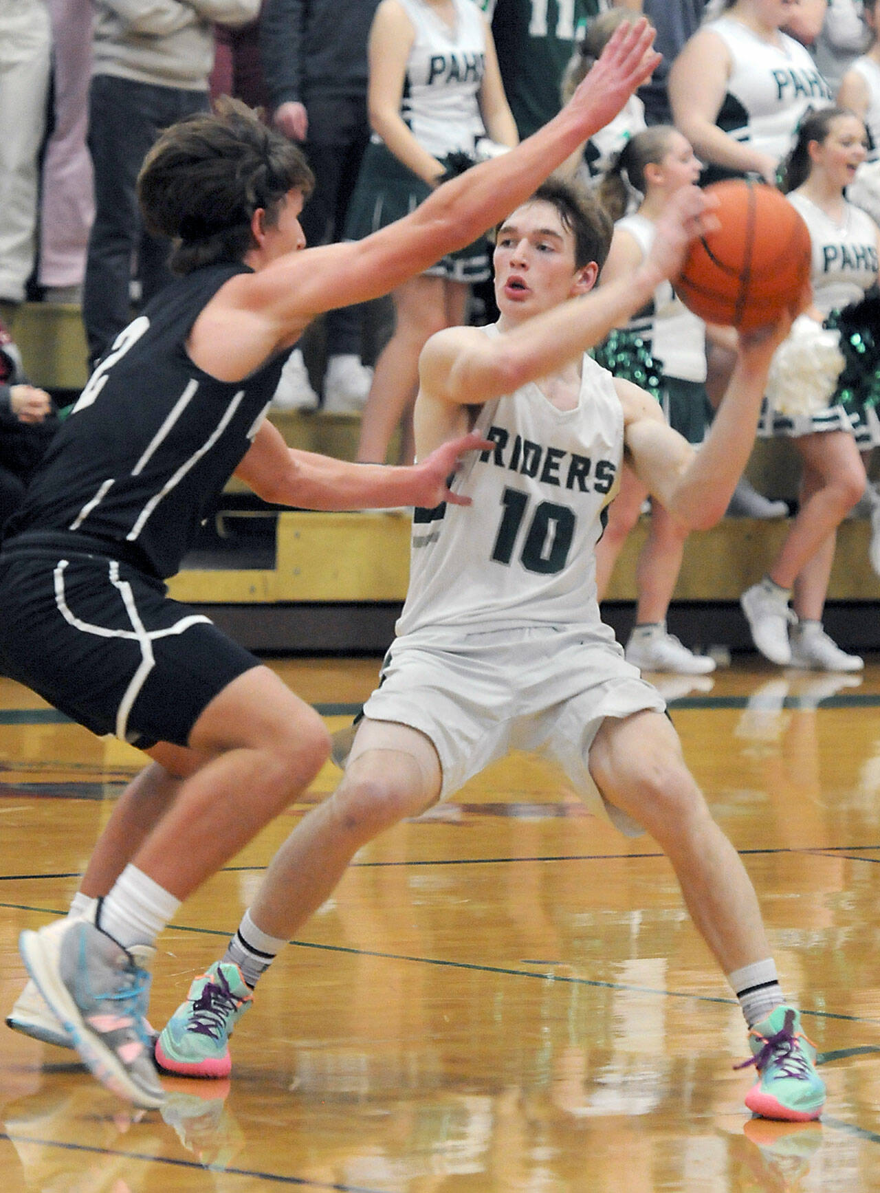 KEITH THORPE/PENINSULA DAILY NEWS Josiah Long of Port Angeles, right, looks for his teammates as North Kitsap’s Mason Chmielewski blocks the way during Thursday’s game in Port Angeles.