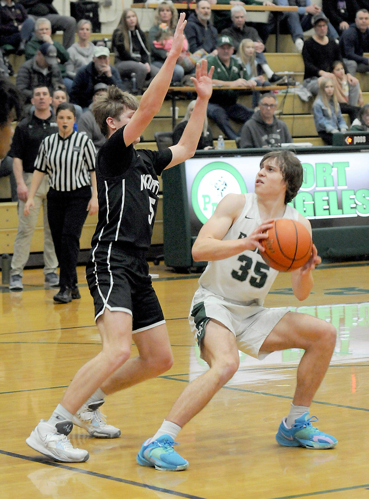 Keith Thorpe/Peninsula Daily News Port Angeles’ Parker Nickerson, right, looks for an opening around the defense of North Kitsap’s Ethan Gillespie on Thursday night in Port Angeles.