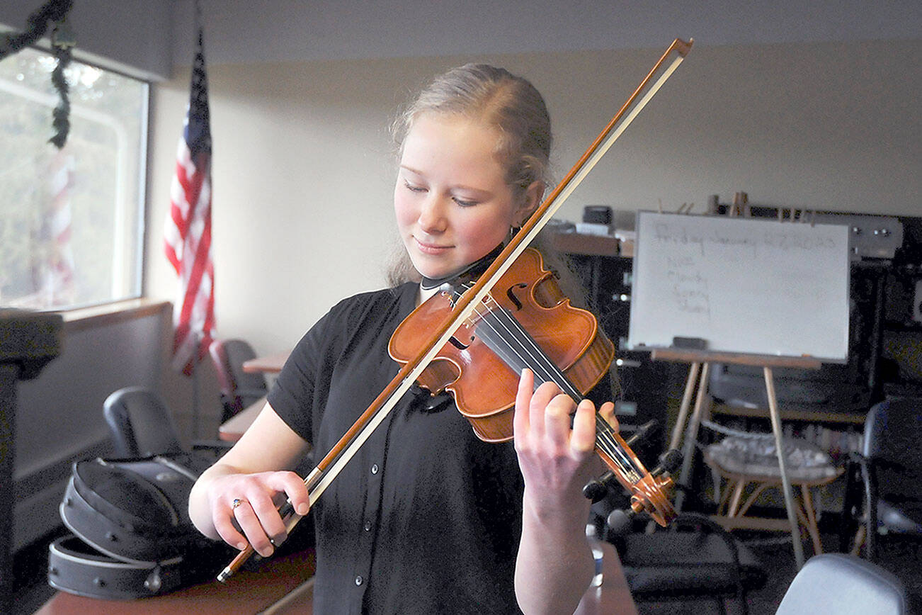 Anabel Moore, 17, of Port Townsend warms up on the violin prior to performing for the judges during Saturday’s 37th annual Nico Snel Young Artist Competition at Holy Trinity Lutheran Church in Port Angeles. Youth musicians from across the North Olympic Peninsula performed classical pieces for cash prizes in an event hosted by the Port Angeles Symphony Orchestra. (Keith Thorpe/Peninsula Daily News)