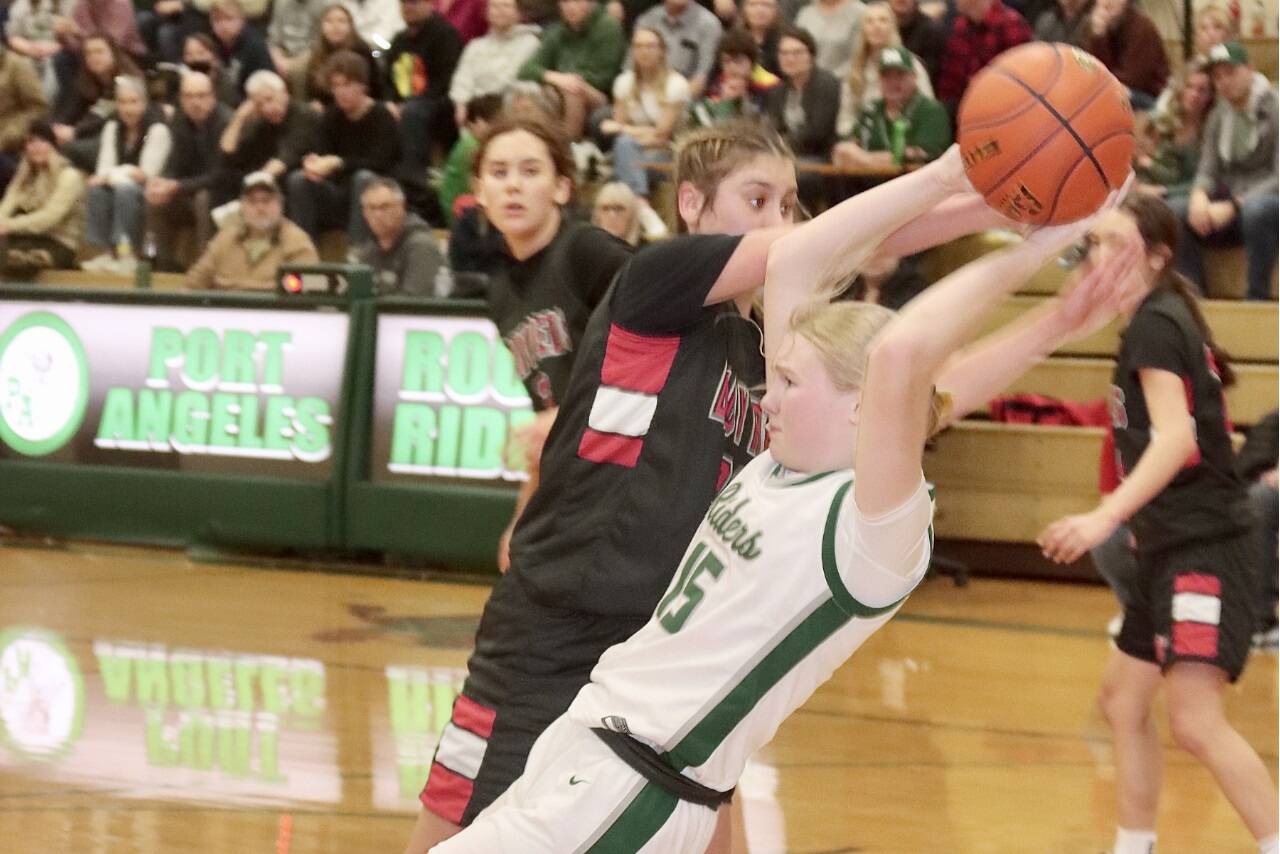 Neah Bay's Ryana Moss and Port Angeles' Paige Mason battle over a rebound Saturday at Port Angeles High School. The No. 1-ranked Red Devils won 60-41. (Dave Logan/for Peninsula Daily News)