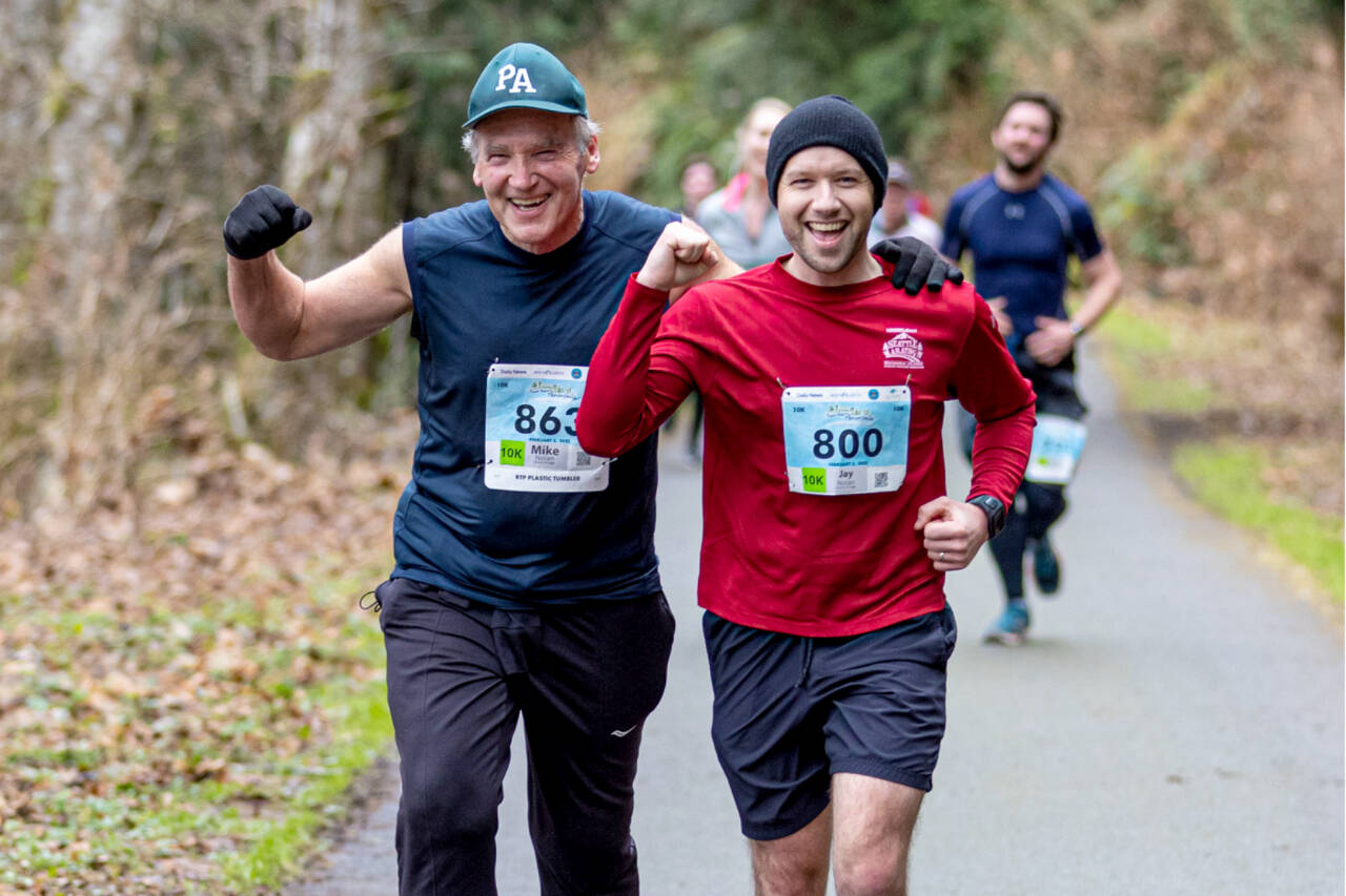 Mike Nolan (863) and Jay Nolan (800) run along the Olympic Discovery Trail in the Elwha Bridge Run 10K in 2022. (Run the Peninsula photo)