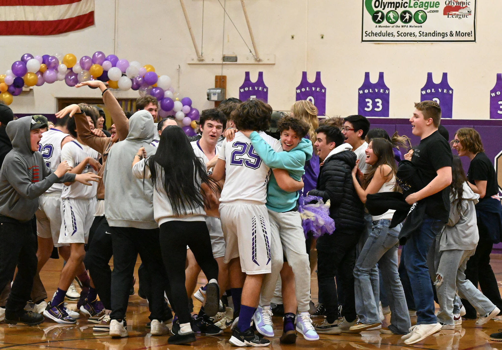 Michael Dashiell/Olympic Peninsula News Group Sequim students and players celebrate the Wolves win over Port Angeles on Thursday. The win snapped a 14-game Riders winning streak dating back to Jan. 29, 2016.
