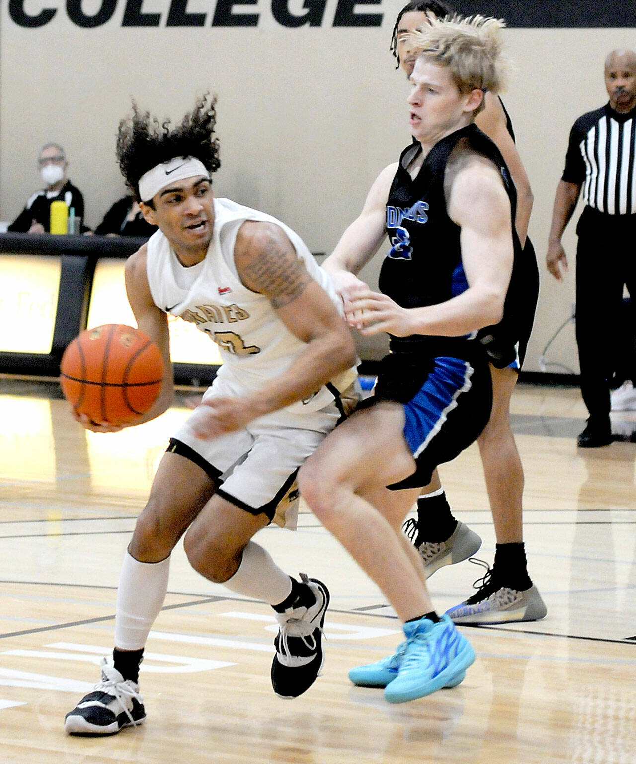 Peninsula’s Roosevelt Williams Jr., left, pushes to the lane around Edmonds’ Hans Stone during Saturday’s NWAC Central game in Port Angeles. (Keith Thorpe/Peninsula Daily News)
