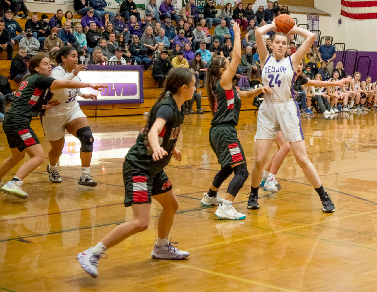 Sequim's Dani Herman looks to pass out of the defense of Neah Bay's Amber Swan, left, Allie Greene and Qwaapeys Greene on Tuesday in Sequim. Also in on the play is Sequim's Jelissa Julmist. (Emily Matthiessen/Olympic Peninsula News Group)