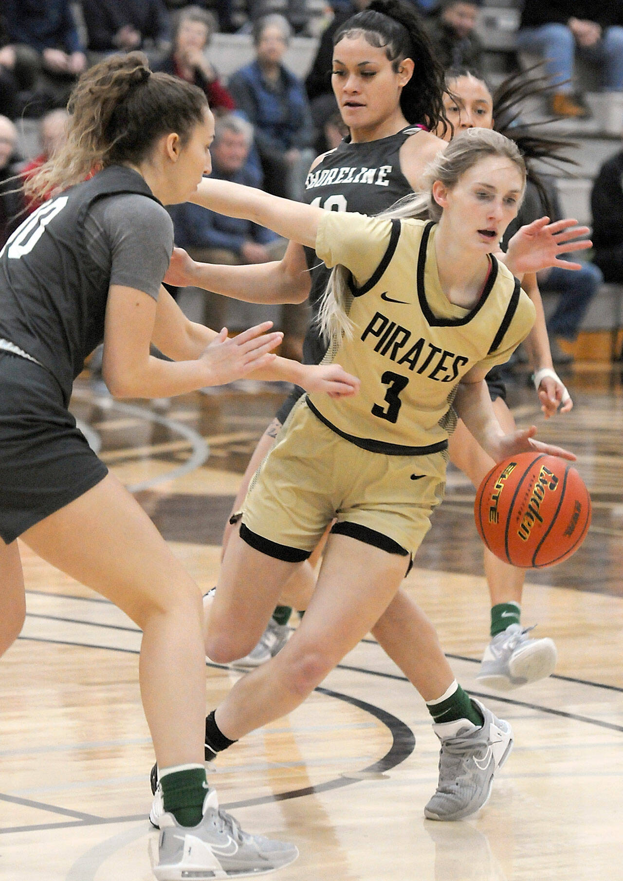 Peninsula’s Millie Long weaves around the defense of Shoreline’s Grace Browning, left, and Aloha Akaka during Saturday’s NWAC North Region game in Port Angeles. (Keith Thorpe/Peninsula Daily News)
