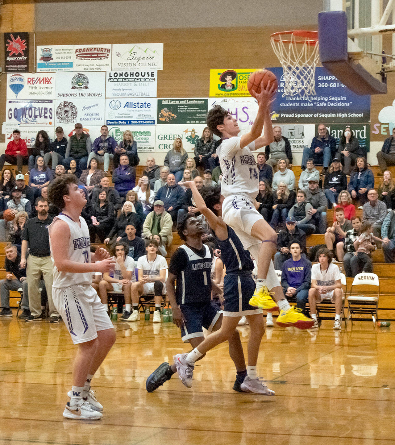 Sequim’s Vince Carrizosa drives the lane for a layup during the Wolves’ 66-37 bi-district tournament win over the Lindbergh Eagles on Wednesday. (Emily Matthiessen/Olympic Peninsula News Group)