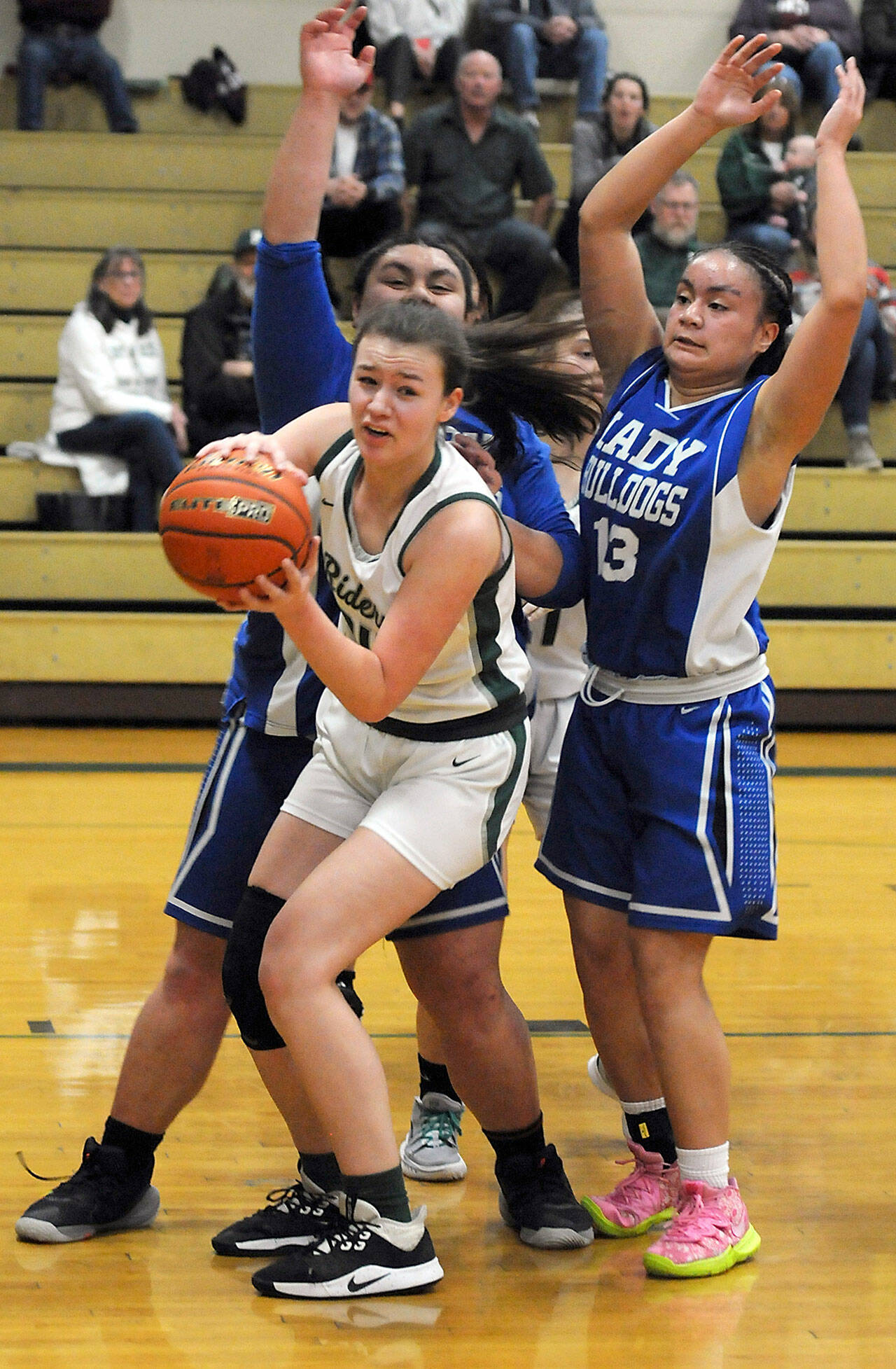 Keith Thorpe/Peninsula Daily News Port Angeles Lexie Smith, front, looks for her teammates as North Masons Tanza Tupolo, left, and Adrianna Tupolo, right, defend the lane during Thursdays district playoff at Port Angeles High School.