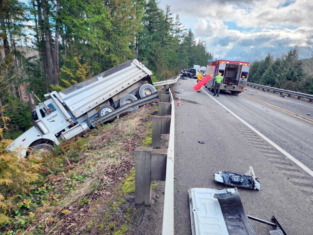 A dump truck was sent over the embankment on state Highway 104 near state Highway 19 when two pickups were involved in a glancing head-on collision shortly before 11 a.m. Friday. (Jefferson County Sheriff’s Office)