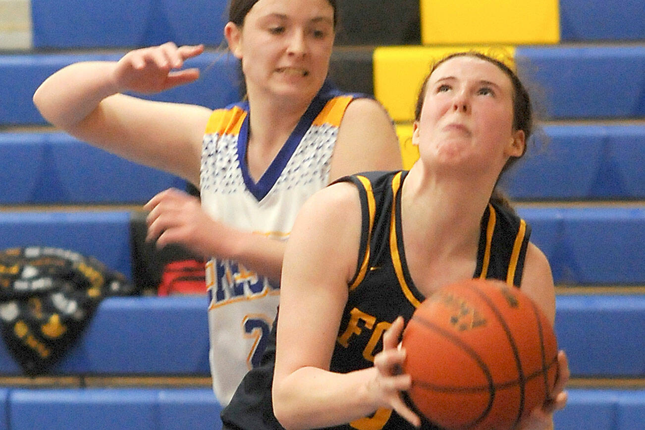 Forks’ Keira Johnson looks for the hoop as Crescent’s Kaylen Mason defends in Joyce in late December. Johnson made the Pacific 2B League first team. (Keith Thorpe/Peninsula Daily News)