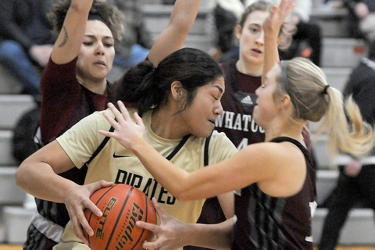 Keith Thorpe/Peninsula Daily News
Peninsula's Ituau Tuisaula, center, finds herself surrounded by Whatcom defenders, from left, Neomi Davidson, Audrey Hansen and Shelby Lund during Wednesday's game in Port Angeles.