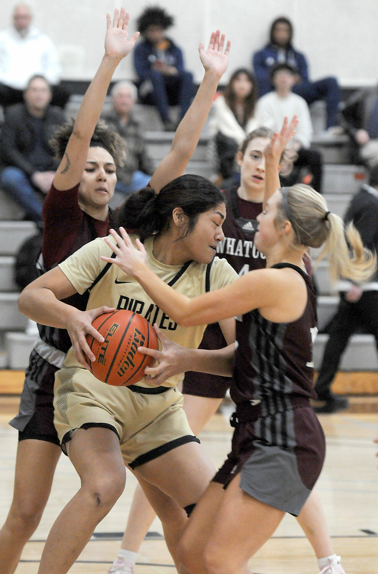 Peninsula’s Ituau Tuisaula, center, finds herself surrounded by Whatcom defenders, from left, Neomi Davidson, Audrey Hansen and Shelby Lund during Wednesday’s game in Port Angeles. (Keith Thorpe/Peninsula Daily News)