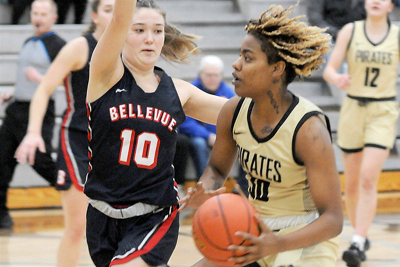 Keith Thorpe/Peninsula Daily News
Peninsula's Chasity Selden, right, drives to the lane as Bellevue's Jadyn Mueller runs interference on Wednesday night in Port Angeles.