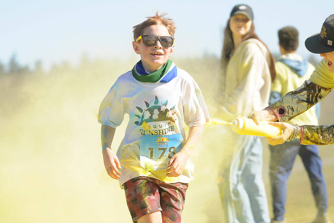 Michael Dashiell/Olympic Peninsula News Group 

Owen DeAngelo grins as he gets a touch of yellow at the last color station at the Sun Fun Color Run 5K in 2022 at the Albert Haller Playfields just north of Carrie Blake Community Park. Entries remain open for the 1K and 5K run/walk races on Saturday.