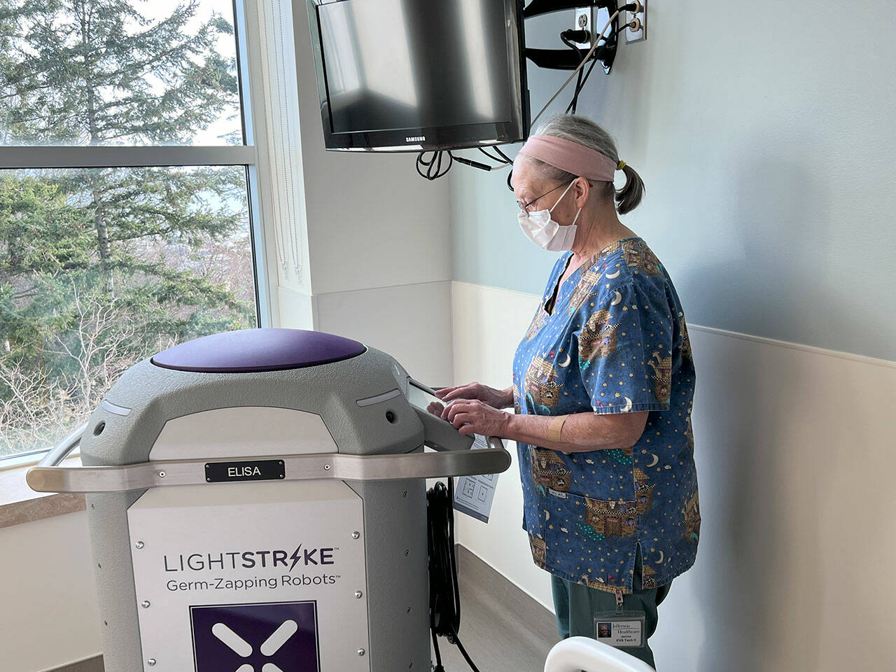Janine Kirby, EVS Tech II, prepares the machine for service. (Jefferson Healthcare)