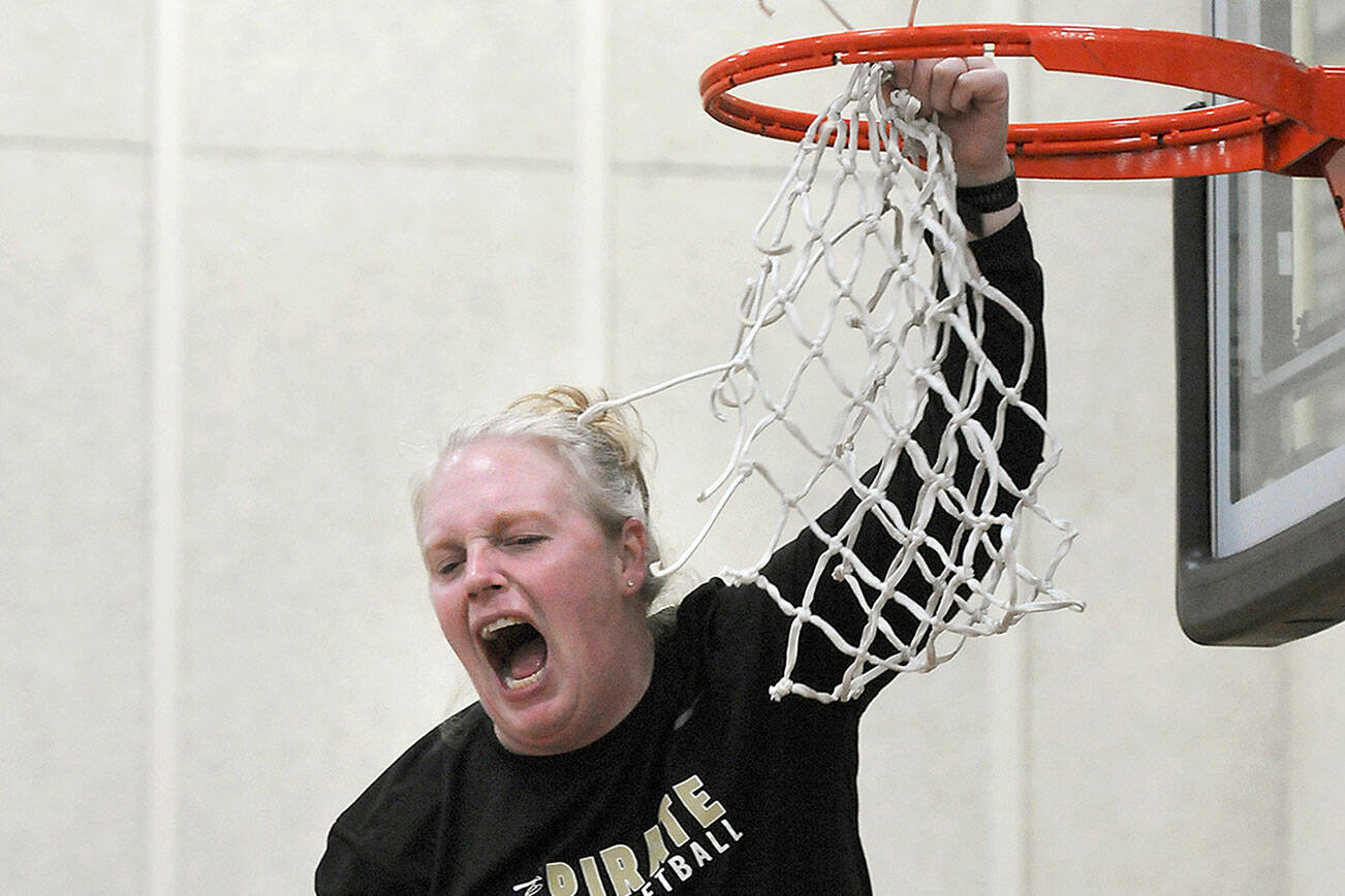 Keith Thorpe/Peninsula Daily News
Peninsula Pirates head coach Ali Crumb emits a scream of excitement as she cuts down the net after her team clinched the NWAC North Region championship by defeating Everett on Wednesday in Port Angeles