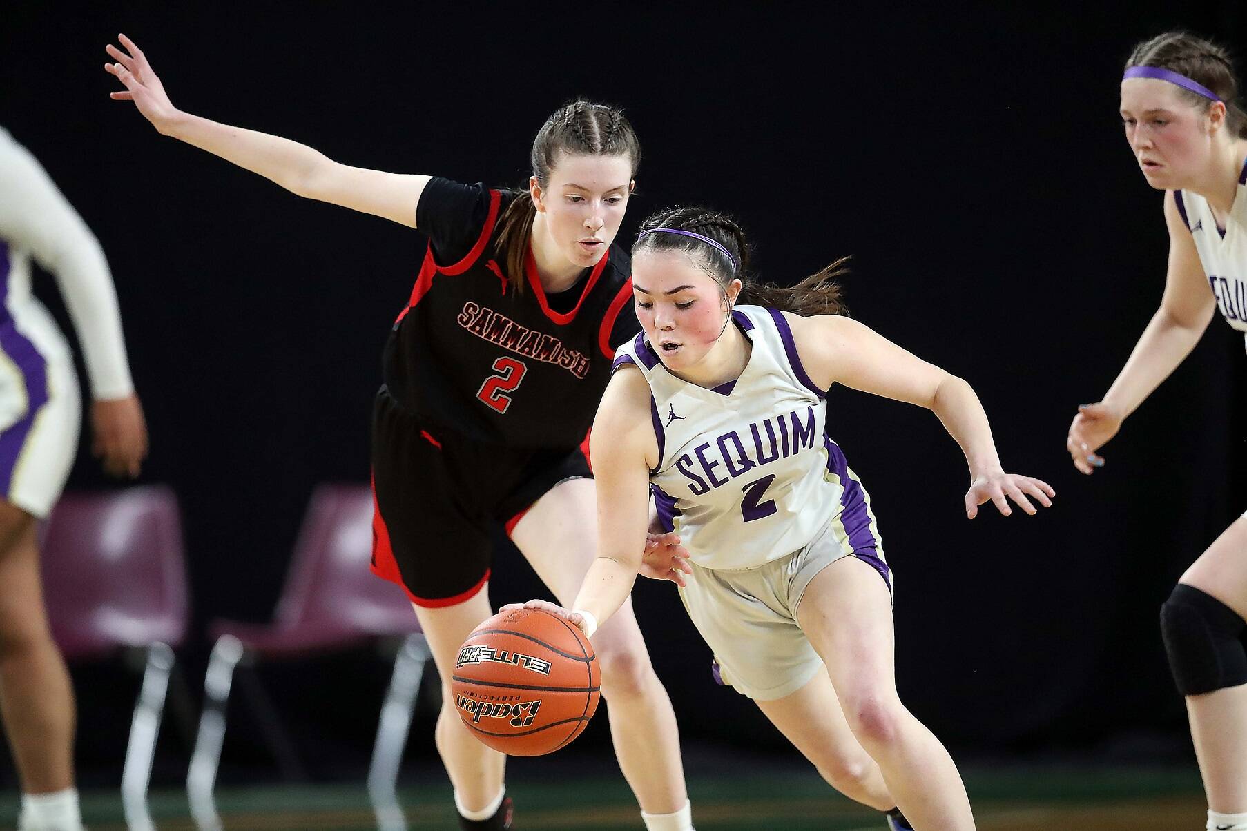 Sequim’s Hannah Bates dribbles against Sammamish Sarah Shaggs in the state 2A tournament Wednesday night. Bates finished with 14 points, seven rebounds and six steals in a 57-37 Sequim victory. (David Willoughby/for Peninsula Daily News)