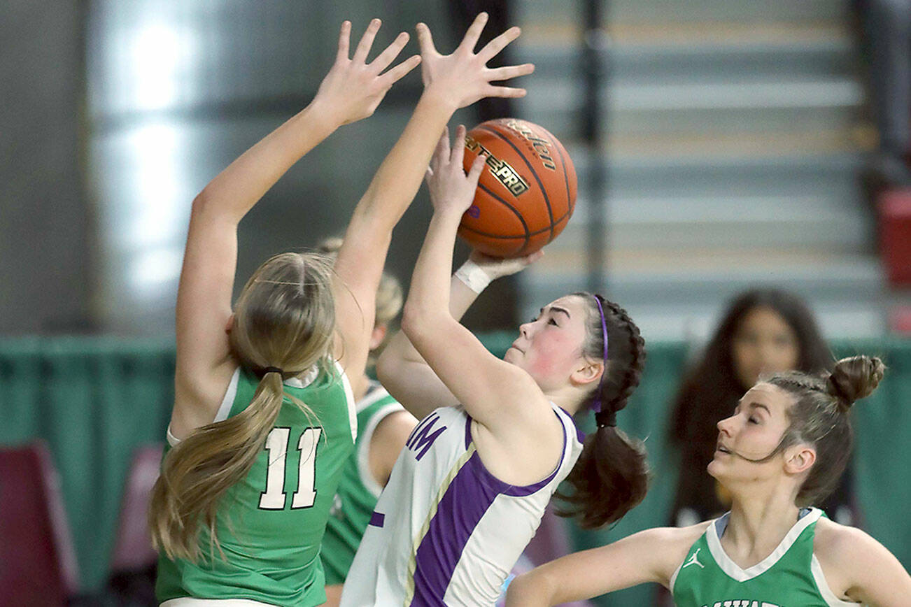 David Willoughby/for Peninsula Daily News
Sequim's Hannah Bates attacks the rim while Tumwater's Kylie Waltermeyer, left, and Hadley Woods defend during the Wolves' 38-24 state victory Friday at the Yakima Valley SunDome.