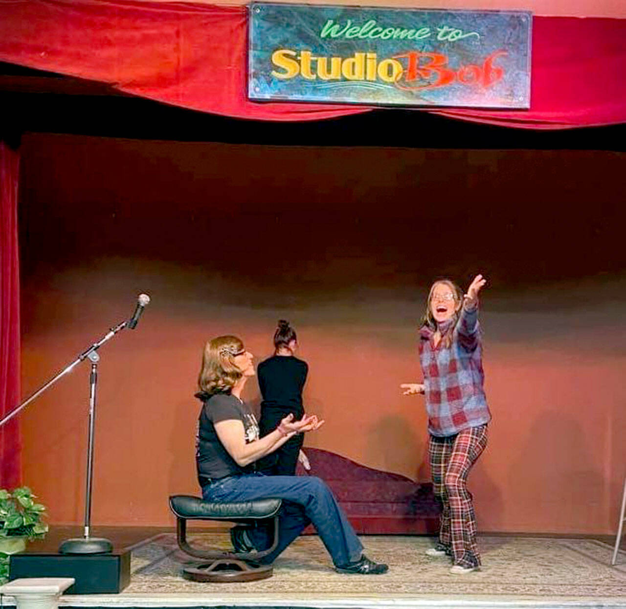 IWANT (Improv Without A Net Troupe) members, from left, Cat White, Kailey Droz and Lara Starcevich rehearse an improv game called Sit, Stand or Wall.