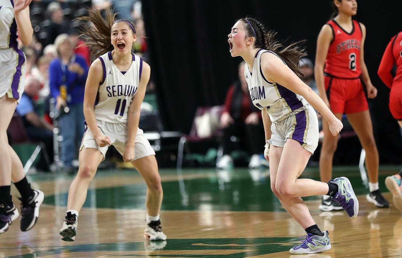 Sequim's Taryn Johnson and Hannah Bates celebrate Bates' game-winning shot against Othello on Saturday morning. Sequim finished fourth at the state 2A girls basketball tournament in Yakima. (David Willoughby/for Peninsula Daily News)