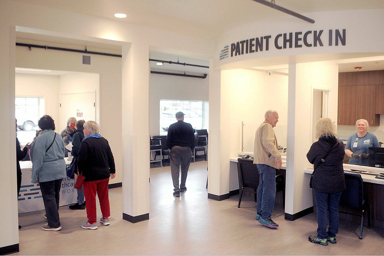 Visitors to the North Olympic Healthcare Network’s new Eastside Clinic look around the entry lobby during an open house on Friday in Port Angeles. (Keith Thorpe/Peninsula Daily News)