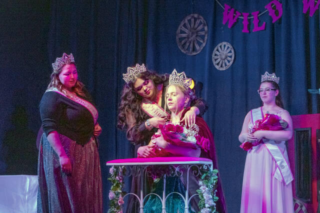 With 2022 Princess Hailey Palmer, left, and 2023 Princess Paige Govia, right, looking on, the newly crowned 2023 Rhody Queen Melody Douglas accepts the cloak of office from 2022 Princess Hailey Hirschel during a coronation at the Jefferson County Fairgrounds on Sunday.