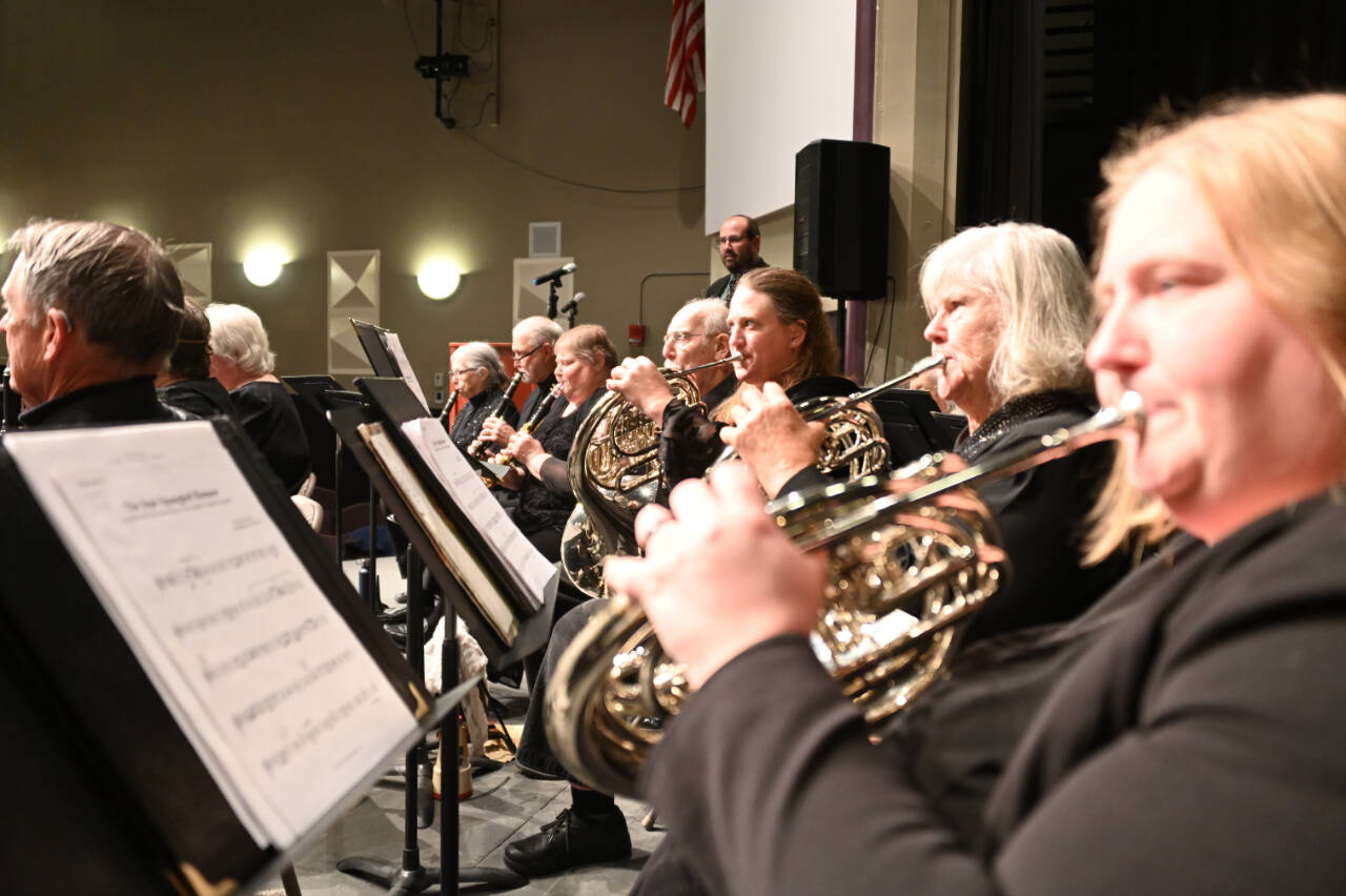 Sequim City Band French horn players and clarinetists tunes as music director Tyler Benedict waits to enter at the band’s Oct. 29, 2022 concert. (Photo by Richard Greenway/Sequim City Band)