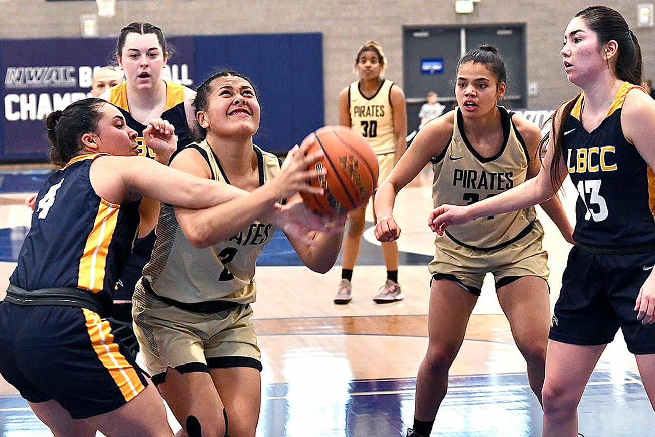 Jay Cline/for Peninsula College
Peninsula's Tati Kamae is fouled by Linn-Benton's Ruby Krebs during the first half of the Pirates' NWAC Women's Basketball Tournament game at Columbia Basin College in Pasco on Thursday.