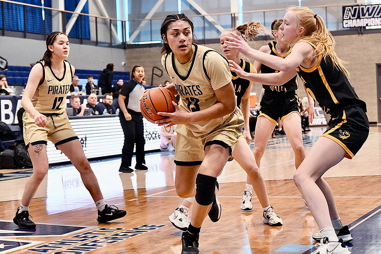 Jay Cline/for Peninsula College
Peninsula's Ituau Tuisaula works down low while guarded by a Walla Walla defender during the Pirates' NWAC Women's Basketball Tournament Quarterfinal on Friday at Columbia Basin College in Pasco.