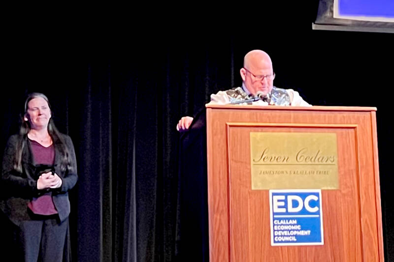 Cynthia Malane, left, accepts the Olympic Leader of the Year award on behalf of her late husband, Ryan Malane, during the Clallam Economic Development Council’s annual gala on Friday night at 7 Cedars Casino. At the podium is Jeremy Weist, plant manager for Port Angeles Hardwood, which was the award sponsor. (Peggy Simmons/Clallam Economic Development Council)