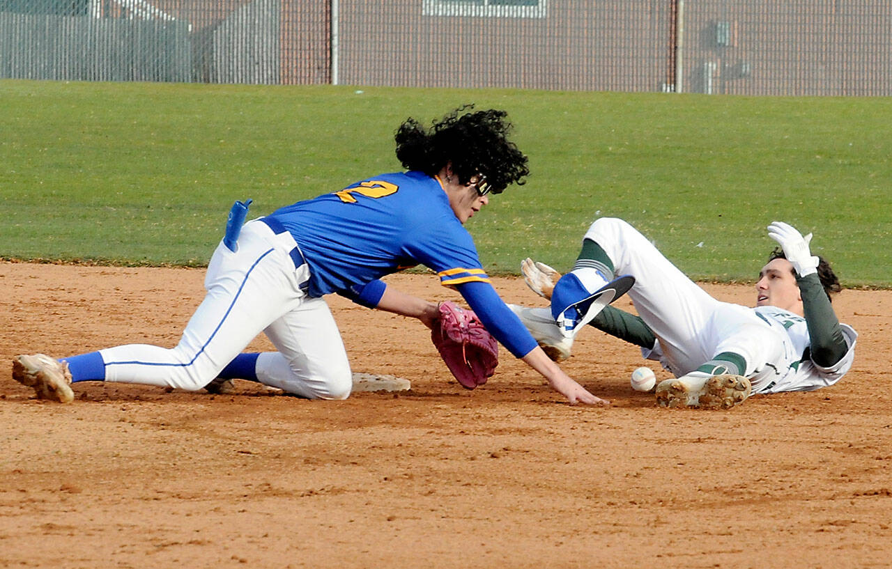 Port Angeles’ Alex Angevine, right, looks back after sliding into second as Bremerton shortstop Brian Infante lets the ball get past him, allioing Angevine to scramble to the bag in the second inning on Tuesday at Port Angeles Civic Field. (Keith Thorpe/Peninsula Daily News)