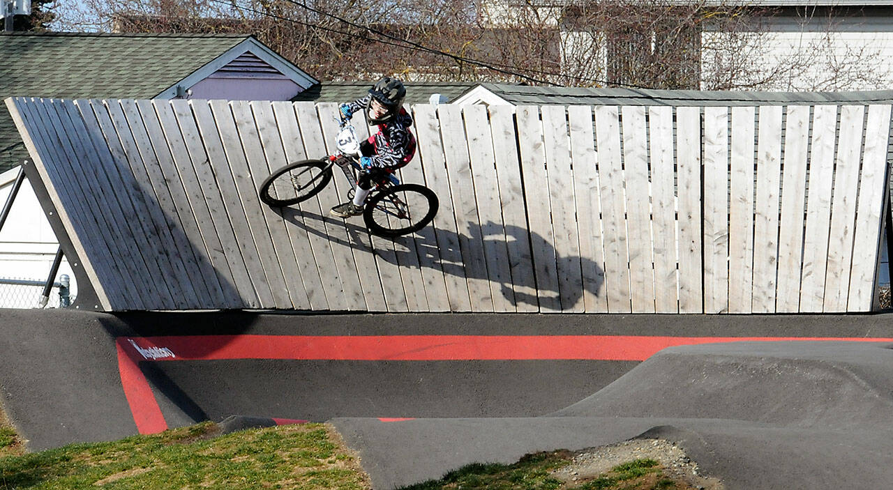 Mason Wilcox-Olton, 8, of Port Angeles casts a shadow on a high-banked curve at the Port Angeles Pump Track at Erickson Playfield on Wednesday. (KEITH THORPE/PENINSULA DAILY NEWS)