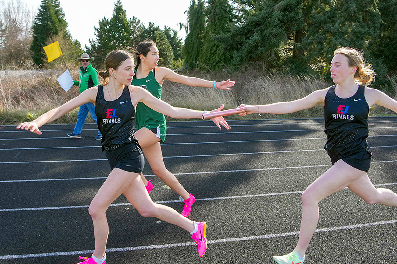 Steve Mullensky/for Peninsula Daily News

Rivals' Audry Matthes hands off to Kay Botkin in the first leg of the 1x400 meter relay during a track meet at Blue Heron Middle School on Thursday. The team, including Aliyah Yearian and Camryn Hines won the event