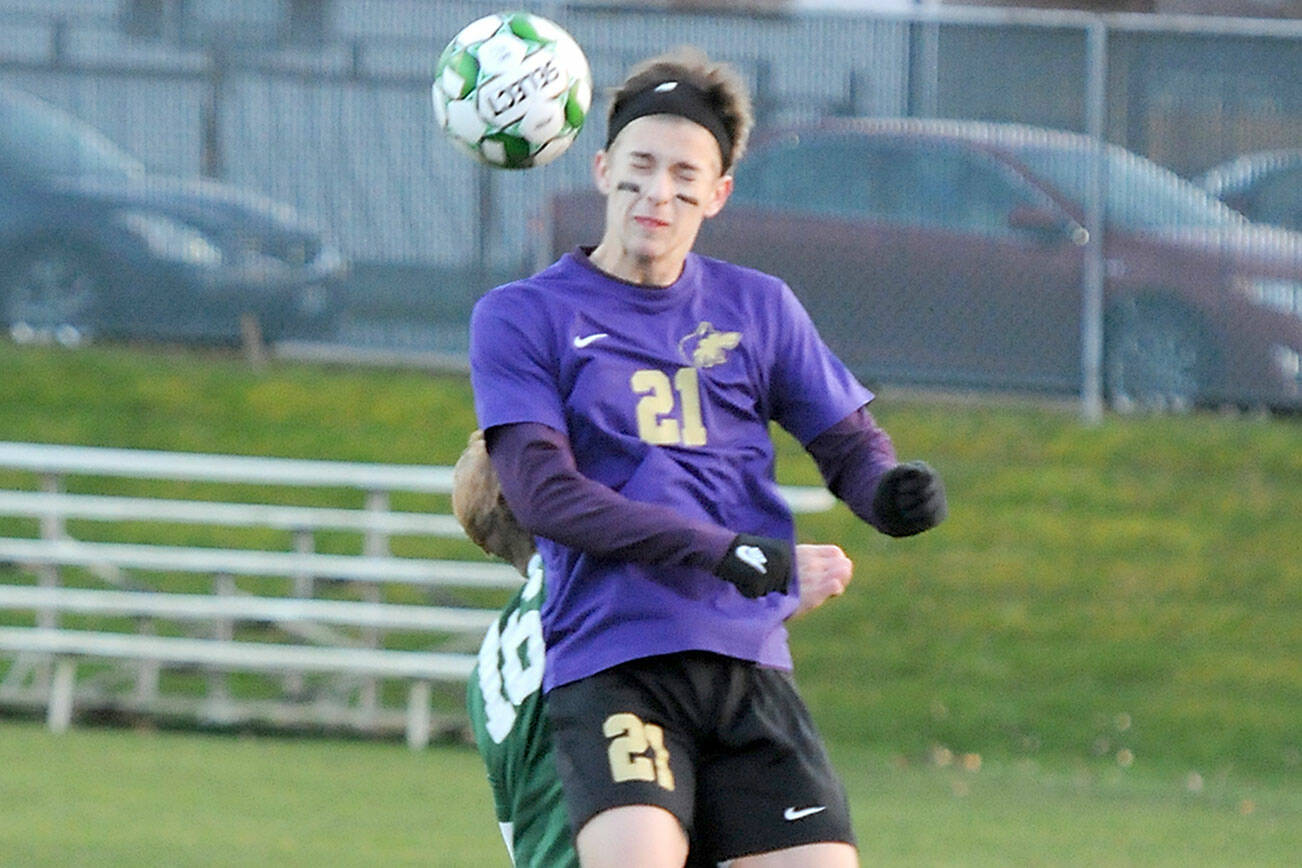 KEITH THORPE/PENINSULA DAILY NEWS
Sequim's Preston Kurtze take the header over the top of Port Angeles' Zak Alton on Thursday in Port Angeles.