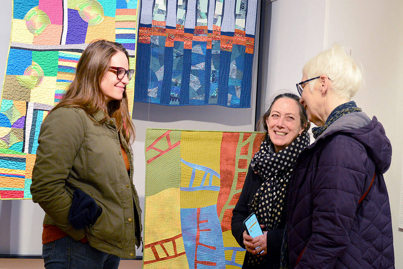 A Grover Gallery visitor talks with teaching artists Barbara Ramsey, far right, and Meg Kaczyk, second from right, during Art Walk earlier this month at the Grover Gallery in downtown Port Townsend. photo courtesy of Northwind Art