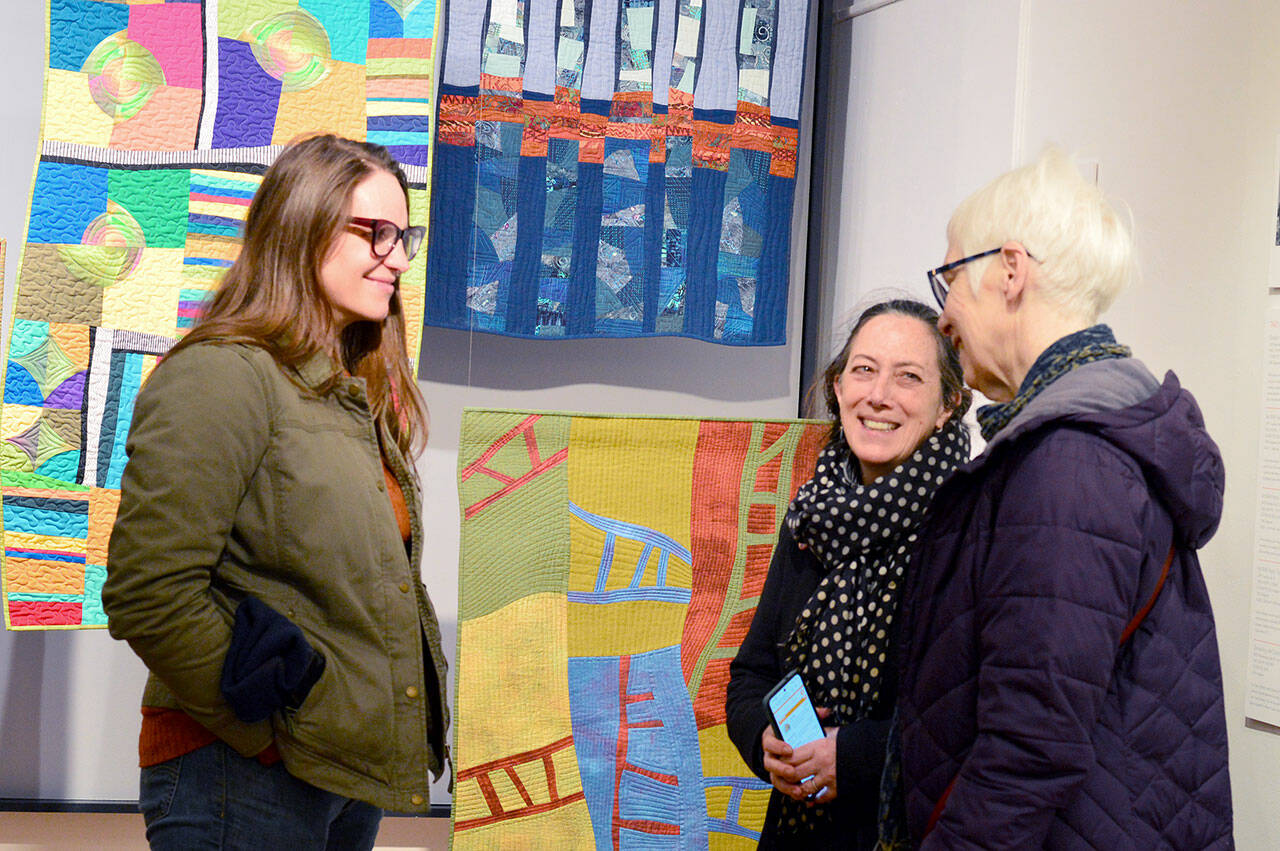 A Grover Gallery visitor talks with teaching artists Barbara Ramsey, far right, and Meg Kaczyk, second from right, during Art Walk earlier this month at the Grover Gallery in downtown Port Townsend. (photo courtesy of Northwind Art)