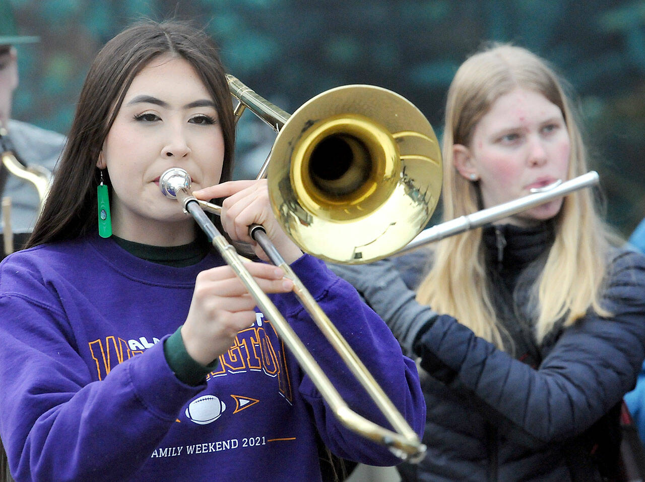 Port Angeles High School sophomore Danika Asgeirsson, 15, left, and young Madeline Irwin, 16, perform with members of the school's band during a fundraising performance at the Conrad Dyar Memorial Fountain in downtown Port Angeles in February.  The band was accepting donations and selling bags of Rainshadow Roasters coffee to help pay for a performance with the school's choir and orchestra at Carnegie Hall in New York City on March 26.  (Keith Thorpe/Peninsula Daily News)