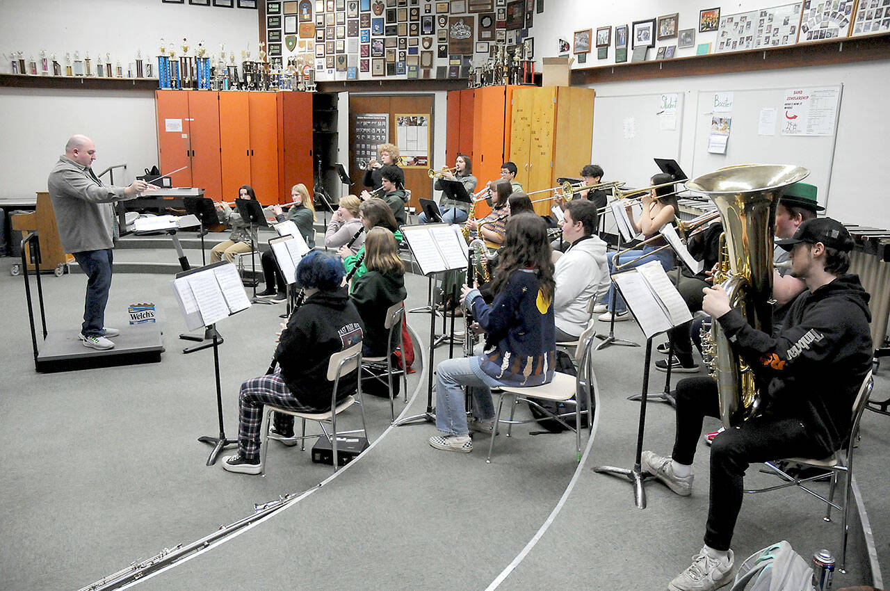 Members of the Port Angeles High School Band, under the direction of Jarrett Hansen, left, practice on Friday in preparation for the group’s upcoming appearance at Carnegie Hall in New York. (Keith Thorpe/Peninsula Daily News)