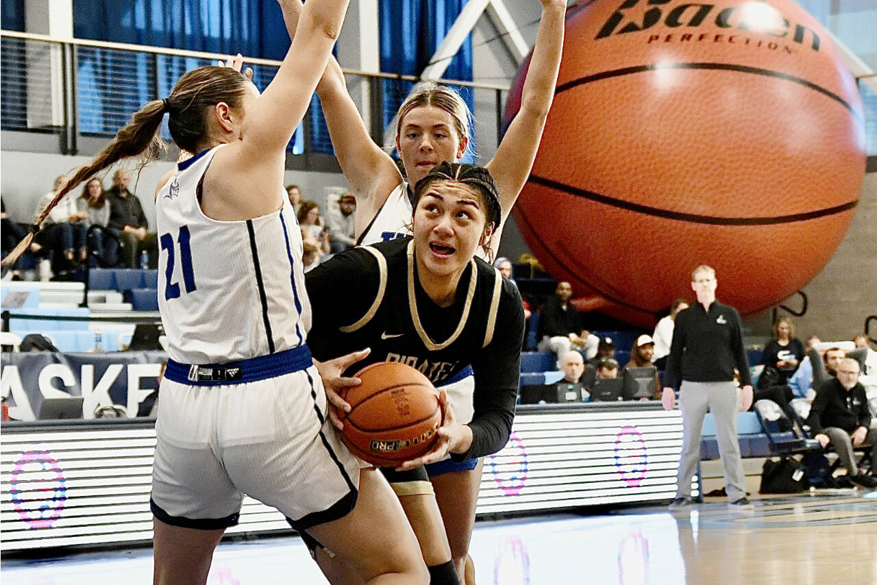 Peninsula’s Itaua Tuisaula battles through a Lane double team during the NWAC semifinals held Saturday in Pasco. Tuisaula had 14 points, 15 rebounds and four blocks before leaving the game with an ankle injury. (Jay Cline/Peninsula College)