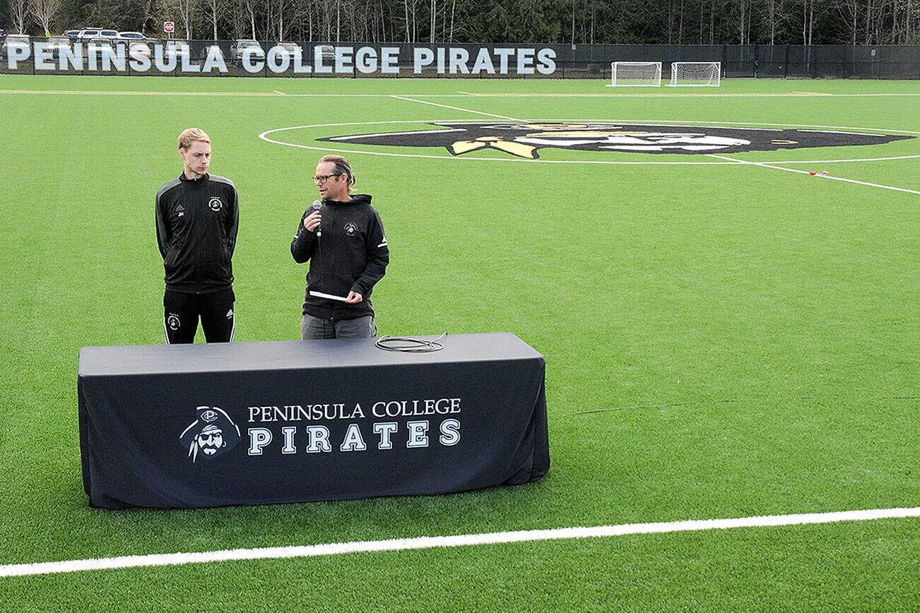 KEITH THORPE/PENINSULA DAILY NEWS
Peninsula College soccer coaches Jake Hughes, left, and Kanyon Anderson speak during the official opening of a new pitch surface at the Wally Sigmar Athletic Complex on Wednesday on the school's Port Angeles campus.