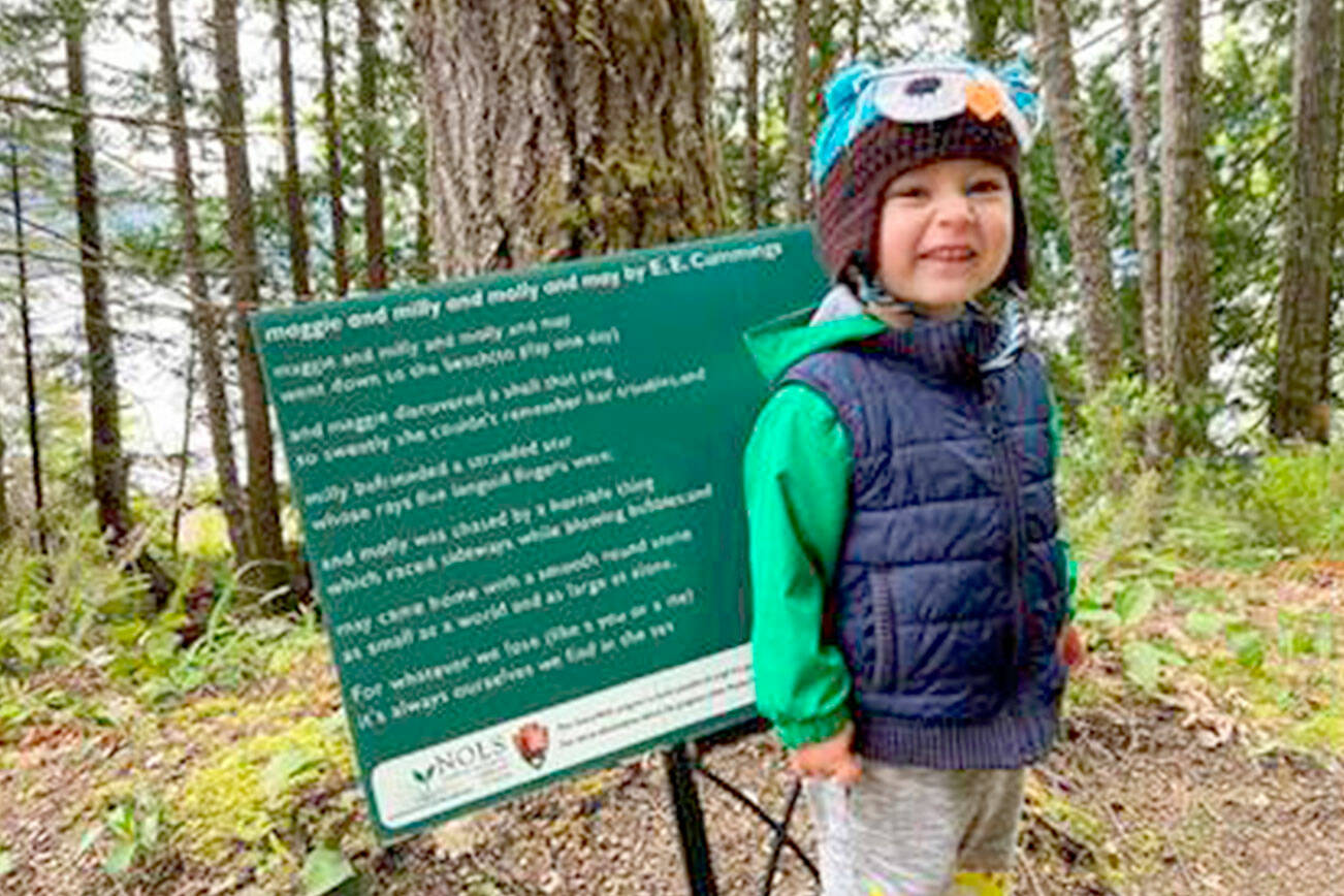 Julie McCord
Brân McCord stands before a poem at the Spruce Railroad Trail in 2022.