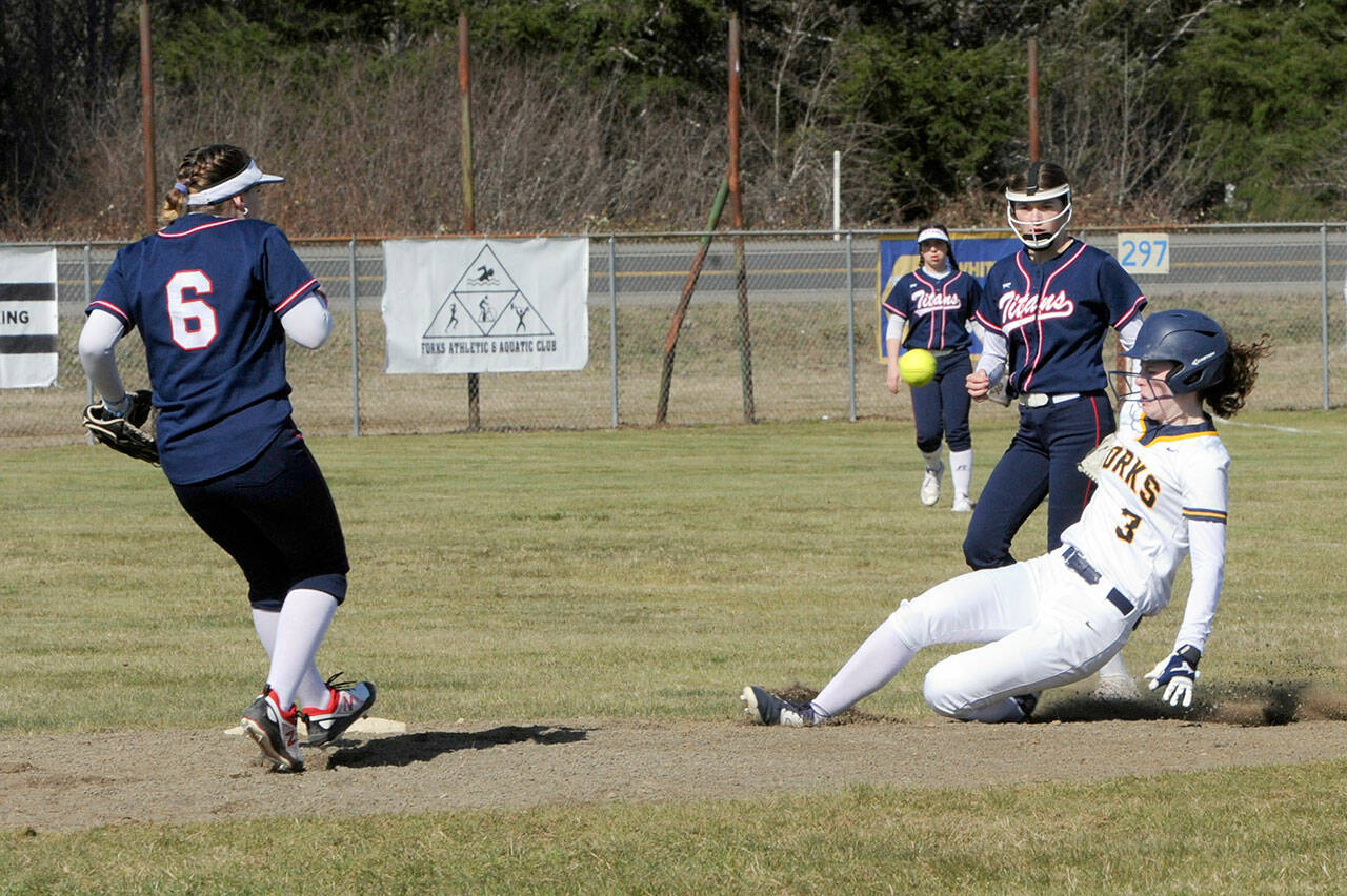 Forks’ Keira Johnson slides in safely with a steal of second base during the Spartans’ doubleheader with Pe Ell on Wednesday at Tillicum Park in Forks. (Lonnie Archibald/for Peninsula Daily News)