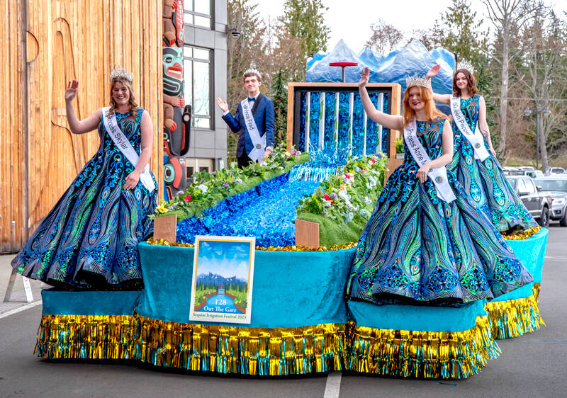 Princess Skylar Kryzworz, Prince Fred Cameron, Princess Anne Marie Barni and Queen Pepper Reymond try out their float for the first time at the kickoff dinner and auction for the Irrigation Festival at the 7 Cedars Resort on Saturday. The float features a changing sign, and real flowing water. (Emily Matthiessen/Olympic Peninsula News Group)