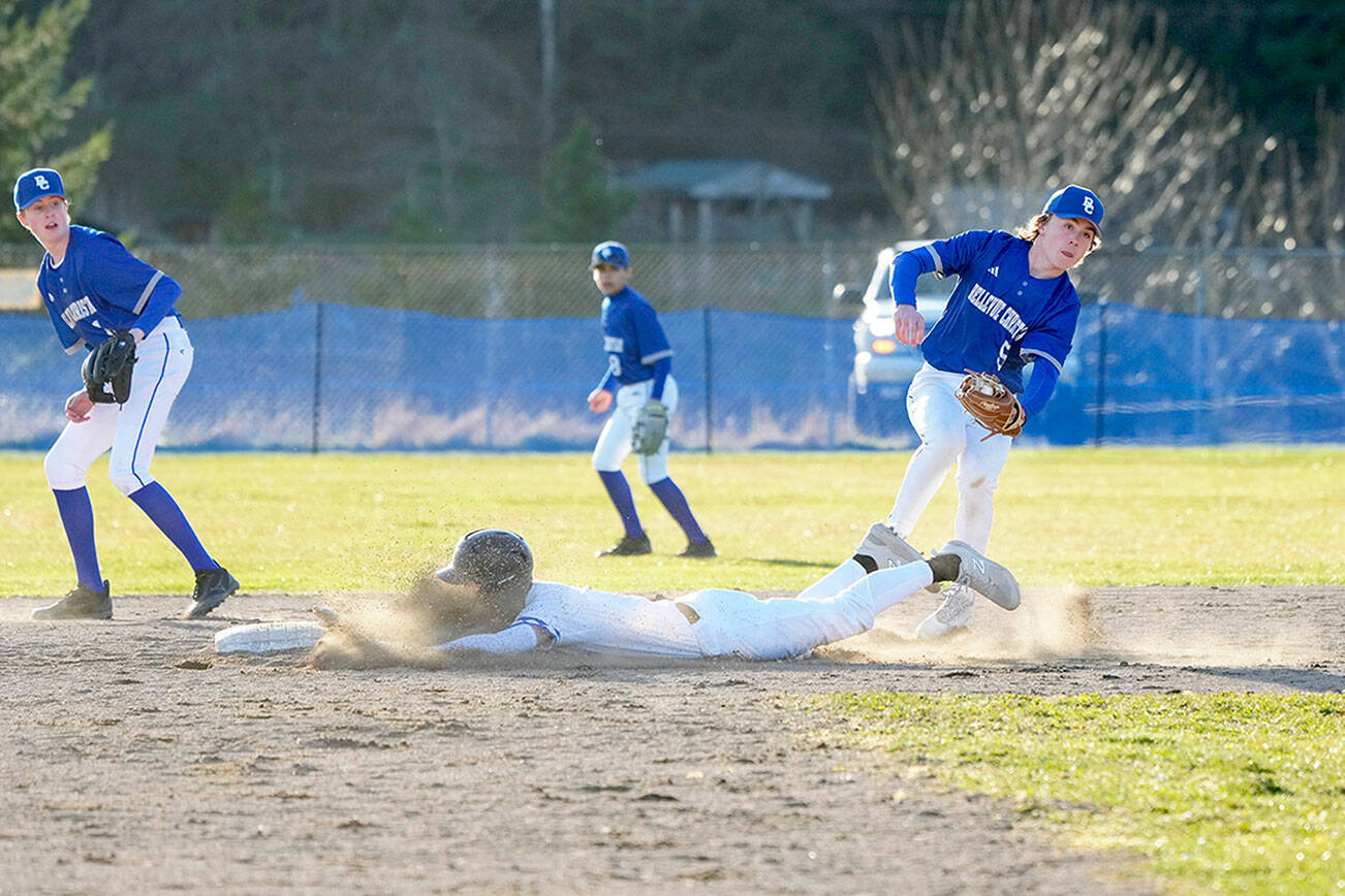 Steve Mullensky/for Peninsula Daily News

East Jefferson Rival Cash Holmes gets a face full of dirt as he beats the throw to Bellevue Christian Viking third baseman Oeclan Englund during a Monday game played in Chimacum.
