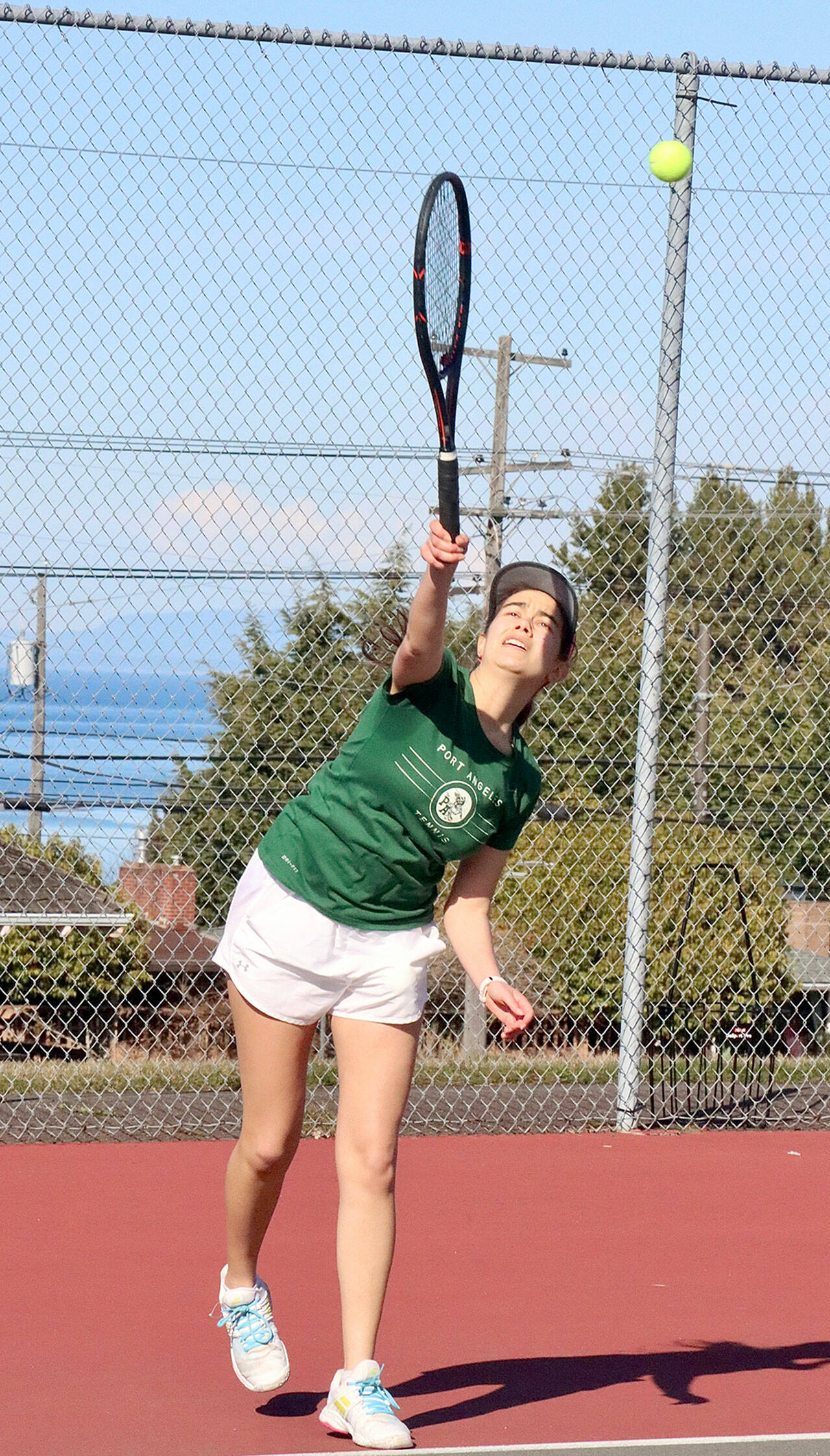 Port Angeles’ Liberty Lauer serves in her No. 1 singles match against Alissa Doyle of Kingston Monday. (Dave Logan/for Peninsula Daily News)