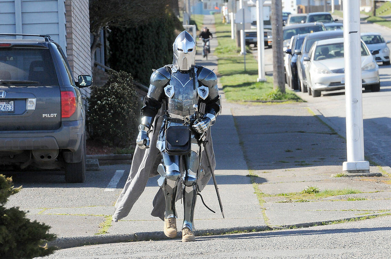 Cavin Vernwald of Port Angeles walks down Lincoln Street in a suit of armor on Wednesday in Port Angeles. (KEITH THORPE/PENINSULA DAILY NEWS)
