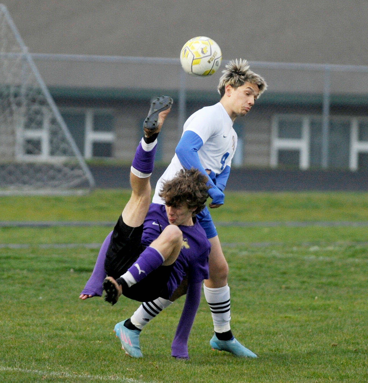 Michael Dashiell/Olympic Peninsula News Group Sequim’s Lake Barrett bicycle kicks the ball over a Bremerton defender during the Wolves’ 2-0 loss at home Thursday.